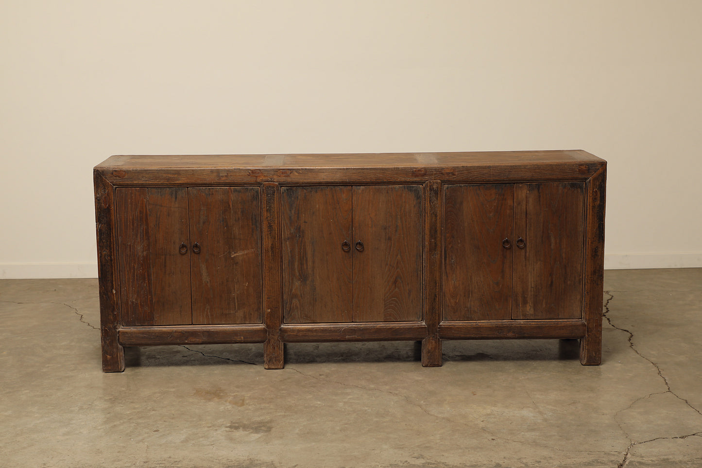 A one-of-a-kind, vintage rustic dark brown sideboard 3 cabinets handcrafted of elm natural wood in a farmhouse style, 85 inches long is narrow at 17 inches.
