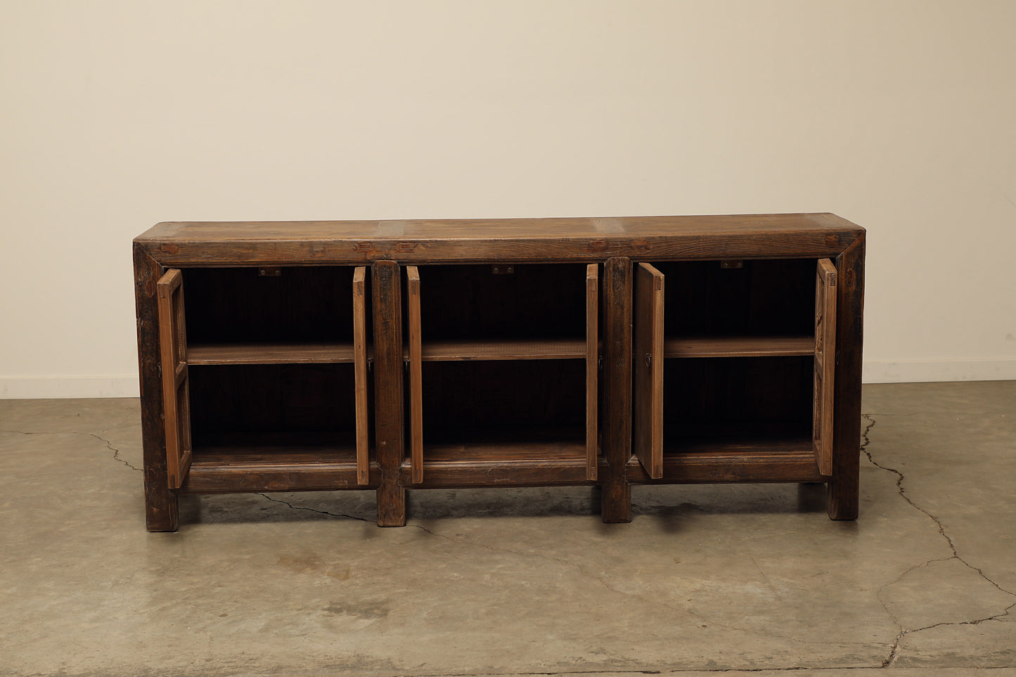 A one-of-a-kind, vintage rustic dark brown sideboard 3 cabinets handcrafted of elm natural wood in a farmhouse style, 85 inches long is narrow at 17 inches.