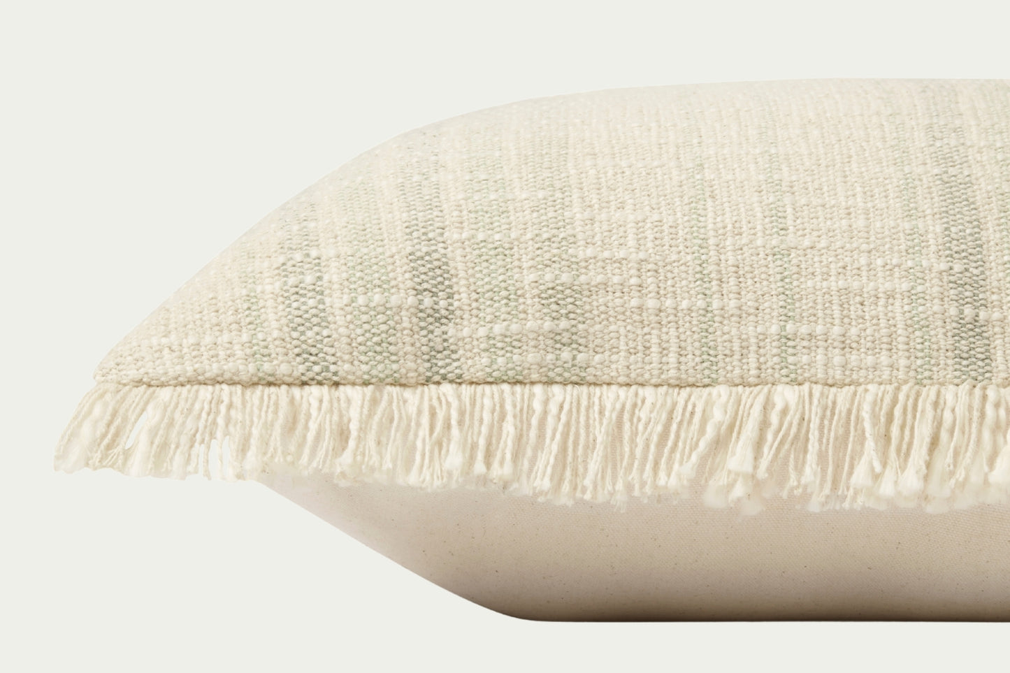 Modern throw pillow features a timeless pattern in an ivory and sage palette in a textural boucle with fringe trim on two sides.