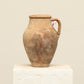 A one-of-a-kind brown Turkish vintage vase pot with a handle, crafted from terra cotta clay, this piece showcases timeless quality and antique craftsmanship, adding a unique touch of history to your space