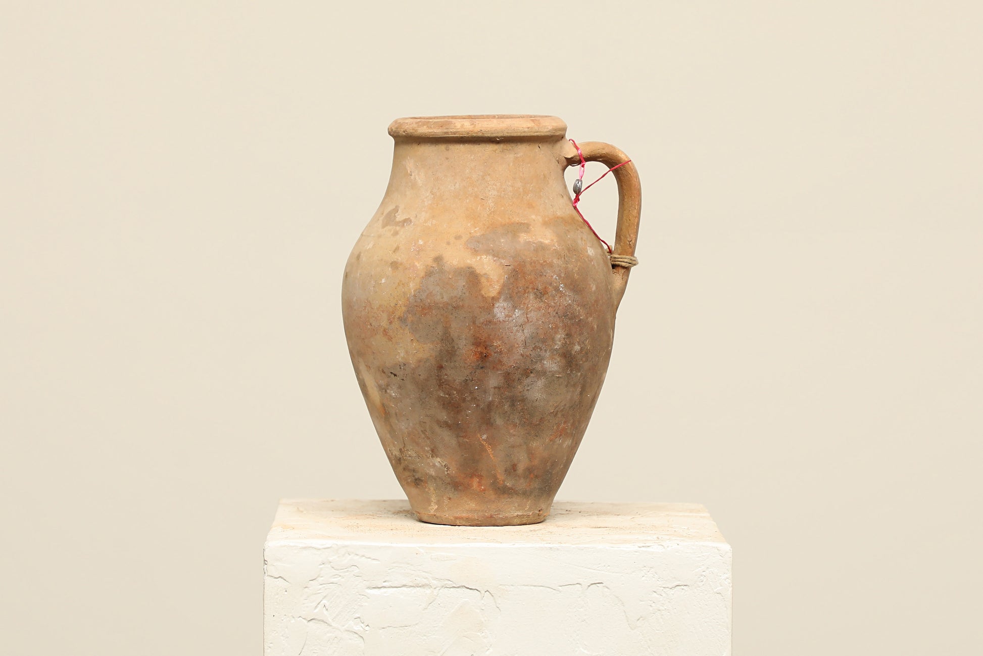 A one-of-a-kind brown Turkish vintage vase pot with a handle, crafted from terra cotta clay, this piece showcases timeless quality and antique craftsmanship, adding a unique touch of history to your space