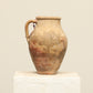 A one-of-a-kind brown Turkish vintage vase pot with a handle, crafted from terra cotta clay, this piece showcases timeless quality and antique craftsmanship, adding a unique touch of history to your space