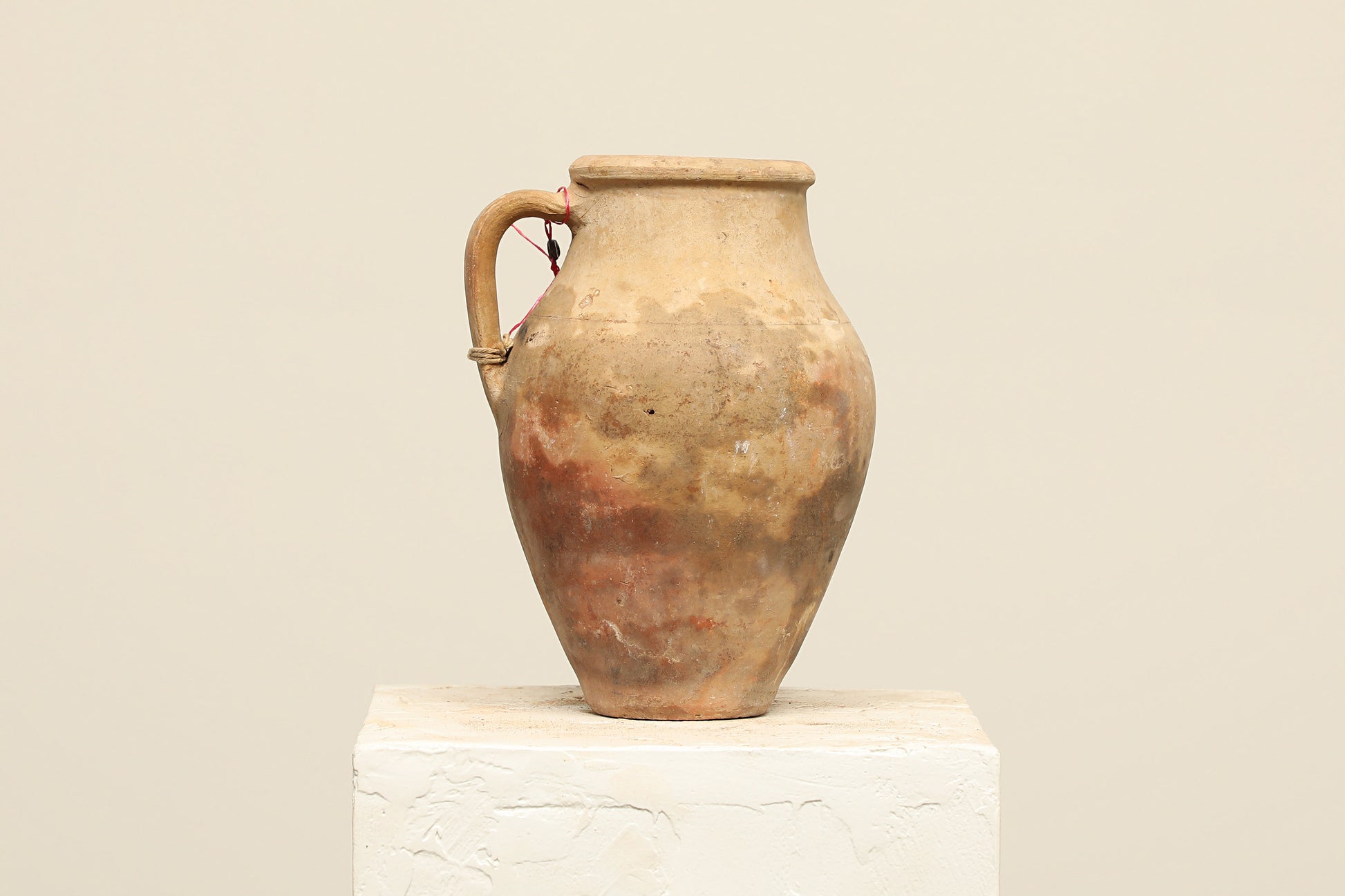 A one-of-a-kind brown Turkish vintage vase pot with a handle, crafted from terra cotta clay, this piece showcases timeless quality and antique craftsmanship, adding a unique touch of history to your space