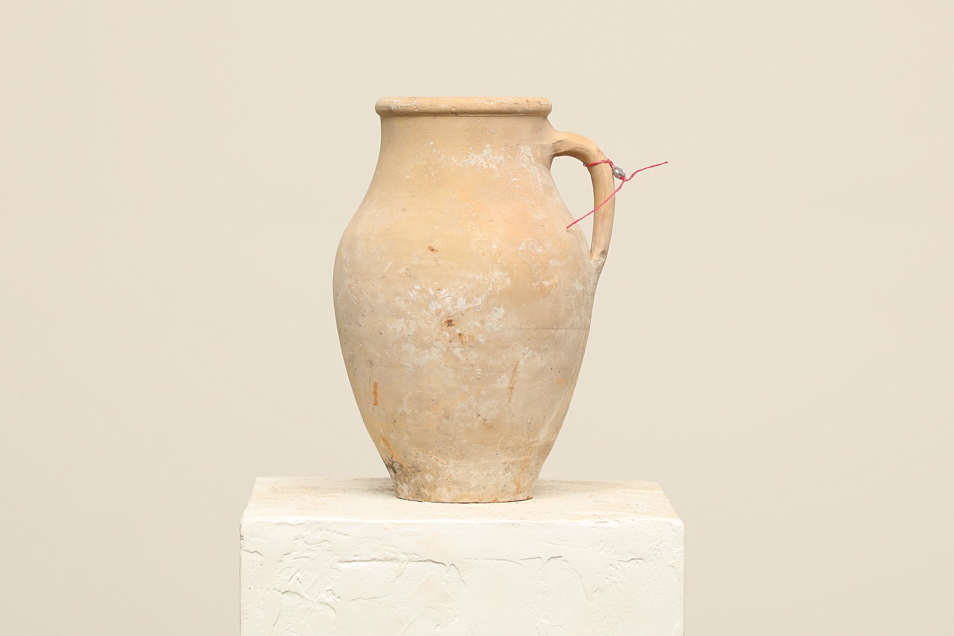A one-of-a-kind clay brown Turkish vintage vase pot with a handle, crafted from terra cotta clay, this piece showcases timeless quality and antique craftsmanship, adding a unique touch of history to your space