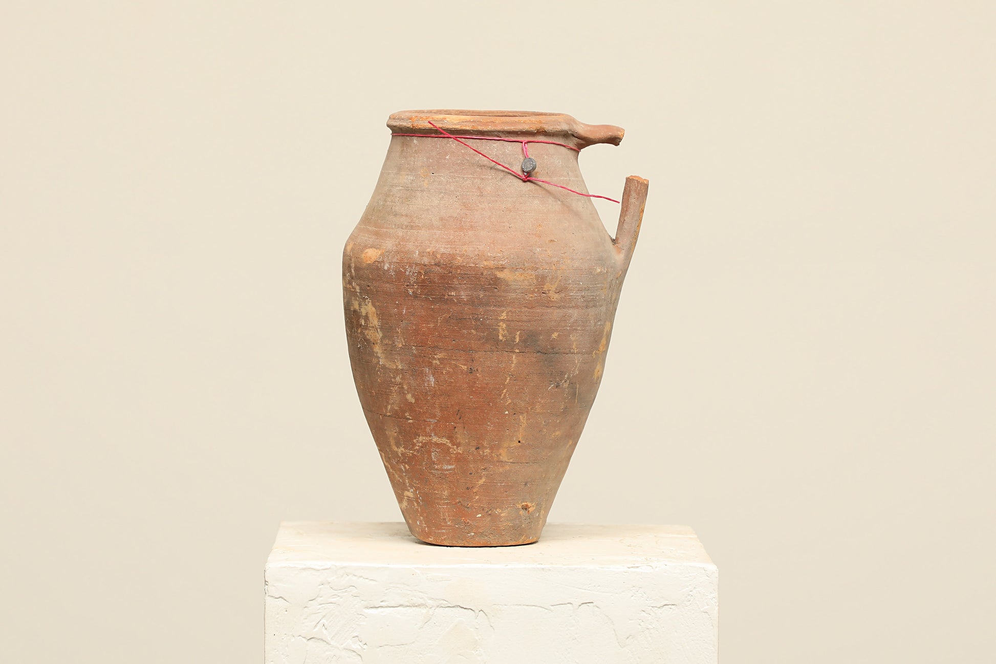 A one-of-a-kind clay brown Turkish vintage vase pot with a handle, crafted from terra cotta clay, this piece showcases timeless quality and antique craftsmanship, adding a unique touch of history to your space
