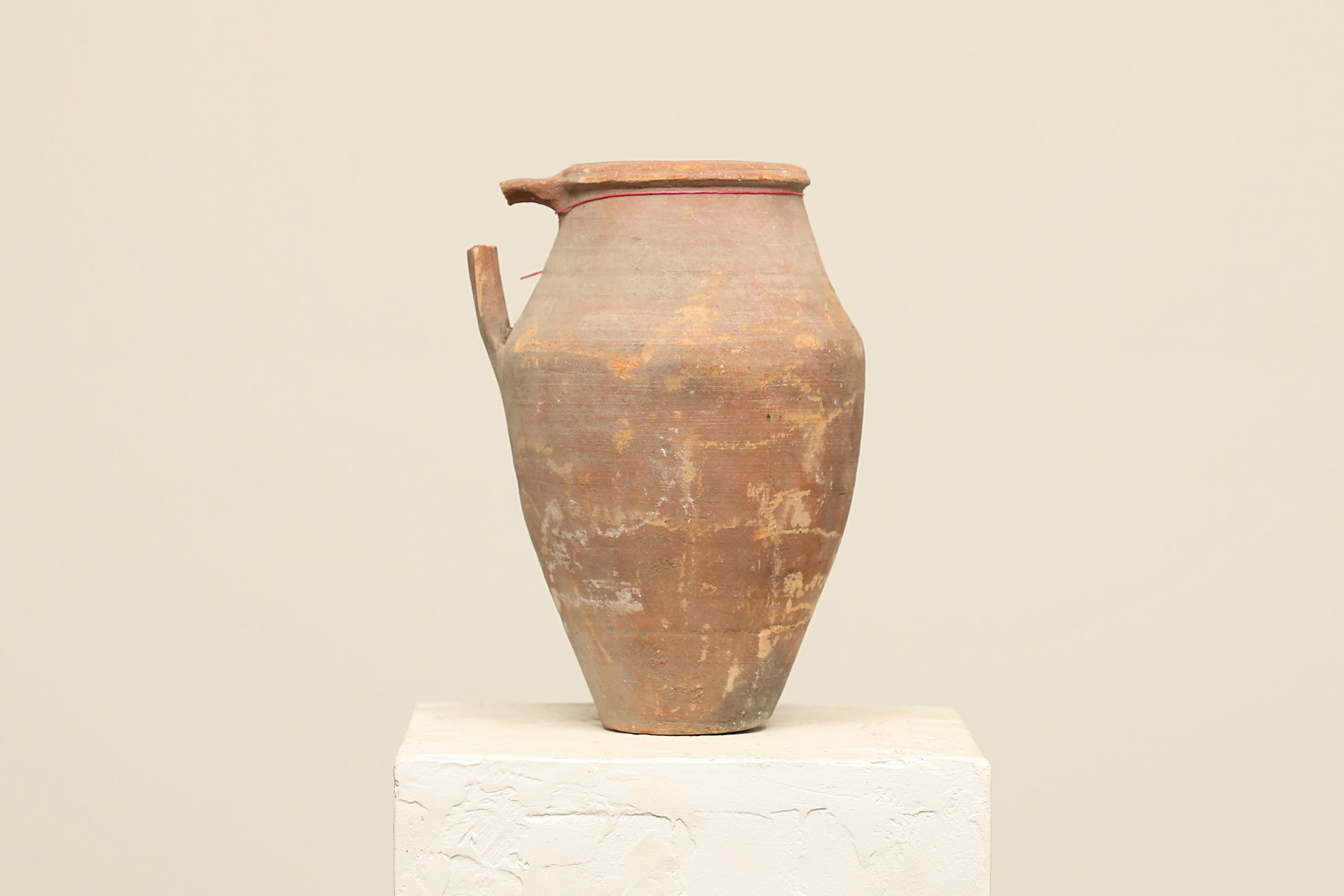 A one-of-a-kind clay brown Turkish vintage vase pot with a handle, crafted from terra cotta clay, this piece showcases timeless quality and antique craftsmanship, adding a unique touch of history to your space