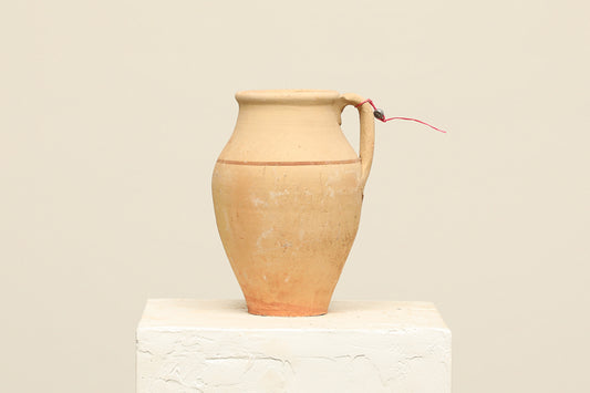 A one-of-a-kind clay brown Turkish vintage vase pot with a handle, crafted from terra cotta clay, this piece showcases timeless quality and antique craftsmanship, adding a unique touch of history to your space