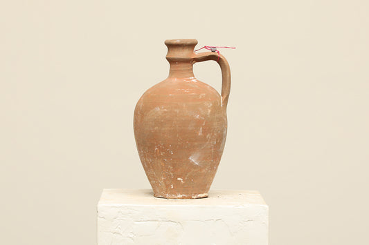 A one-of-a-kind clay brown Turkish vintage vase pot with a handle, crafted from terra cotta clay, this piece showcases timeless quality and antique craftsmanship, adding a unique touch of history to your space