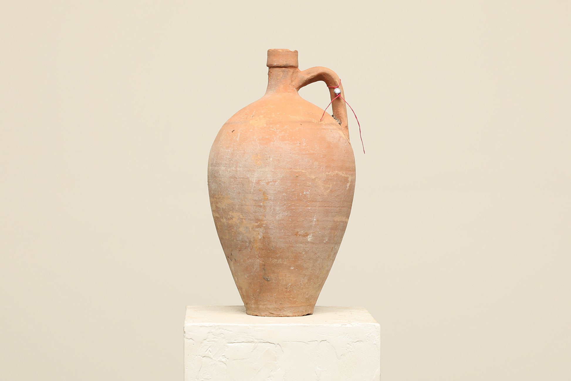 A one-of-a-kind clay brown Turkish vintage vase pot with a handle, crafted from terra cotta clay, this piece showcases timeless quality and antique craftsmanship, adding a unique touch of history to your space