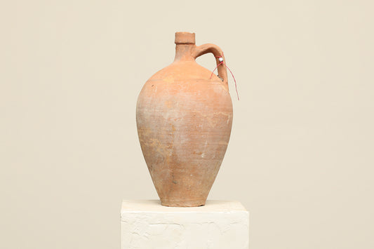 A one-of-a-kind clay brown Turkish vintage vase pot with a handle, crafted from terra cotta clay, this piece showcases timeless quality and antique craftsmanship, adding a unique touch of history to your space