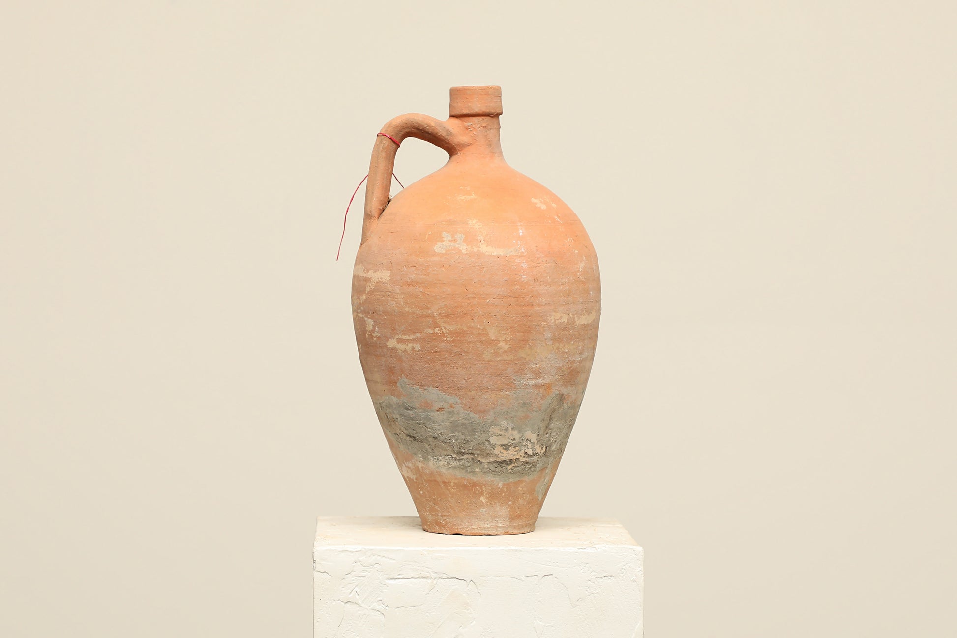 A one-of-a-kind clay brown Turkish vintage vase pot with a handle, crafted from terra cotta clay, this piece showcases timeless quality and antique craftsmanship, adding a unique touch of history to your space