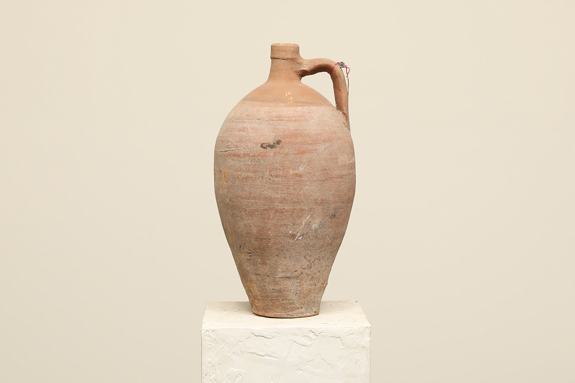 A one-of-a-kind clay brown Turkish vintage vase pot with a handle, crafted from terra cotta clay, this piece showcases timeless quality and antique craftsmanship, adding a unique touch of history to your space