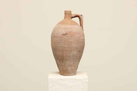 A one-of-a-kind clay brown Turkish vintage vase pot with a handle, crafted from terra cotta clay, this piece showcases timeless quality and antique craftsmanship, adding a unique touch of history to your space