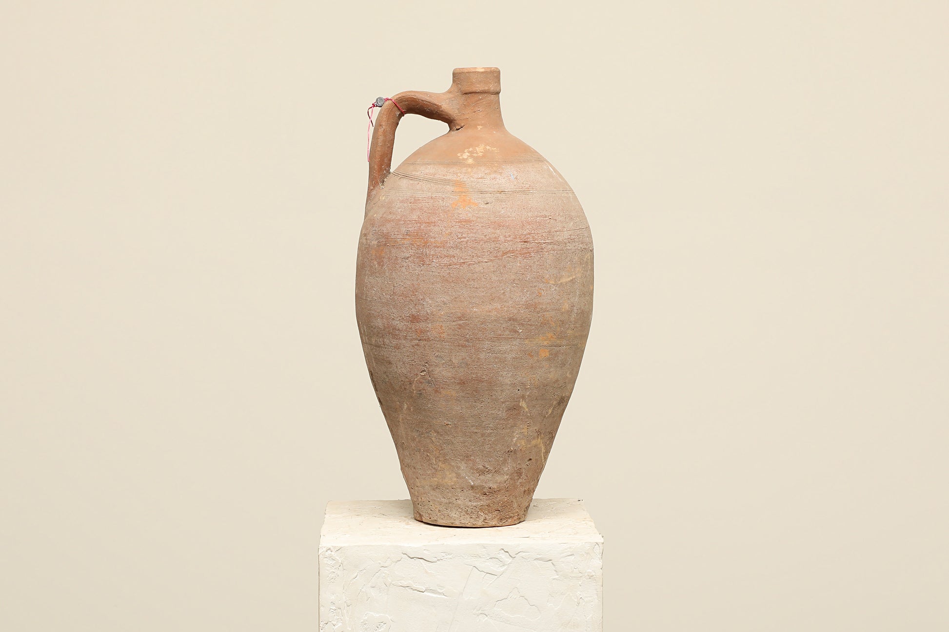 A one-of-a-kind clay brown Turkish vintage vase pot with a handle, crafted from terra cotta clay, this piece showcases timeless quality and antique craftsmanship, adding a unique touch of history to your space