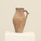 A one-of-a-kind clay brown Turkish vintage vase pot with a handle, crafted from terra cotta clay, this piece showcases timeless quality and antique craftsmanship, adding a unique touch of history to your space