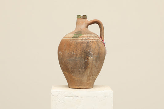 A one-of-a-kind clay brown Turkish vintage vase pot with a handle, crafted from terra cotta clay, this piece showcases timeless quality and antique craftsmanship, adding a unique touch of history to your space