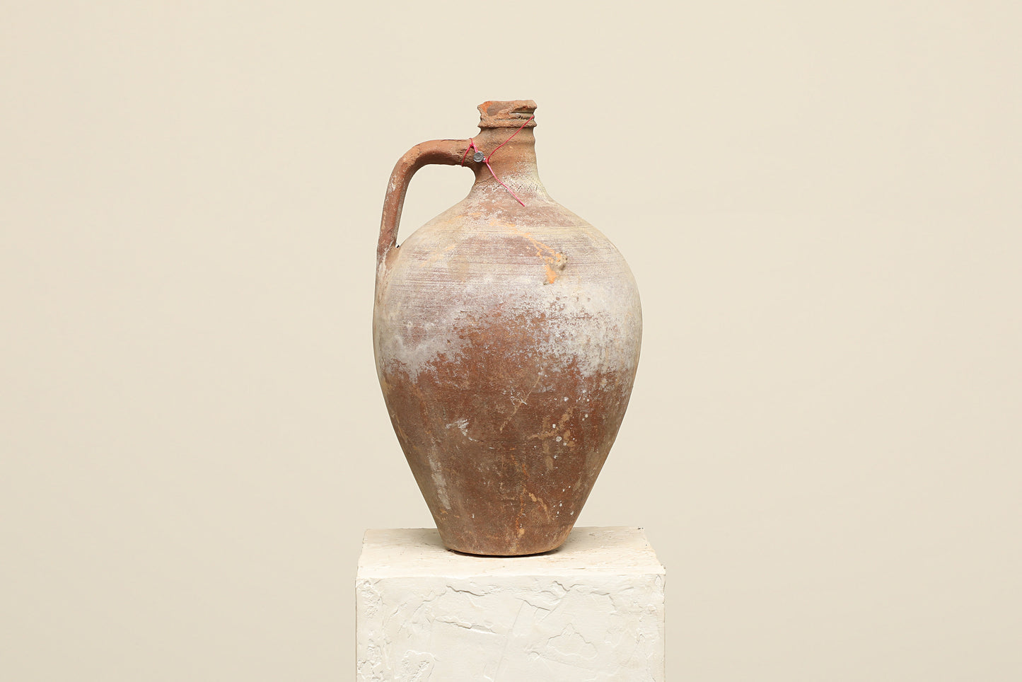 A one-of-a-kind clay brown Turkish vintage vase pot with a handle, crafted from terra cotta clay, this piece showcases timeless quality and antique craftsmanship, adding a unique touch of history to your space