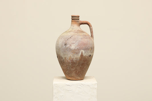 A one-of-a-kind clay brown Turkish vintage vase pot with a handle, crafted from terra cotta clay, this piece showcases timeless quality and antique craftsmanship, adding a unique touch of history to your space