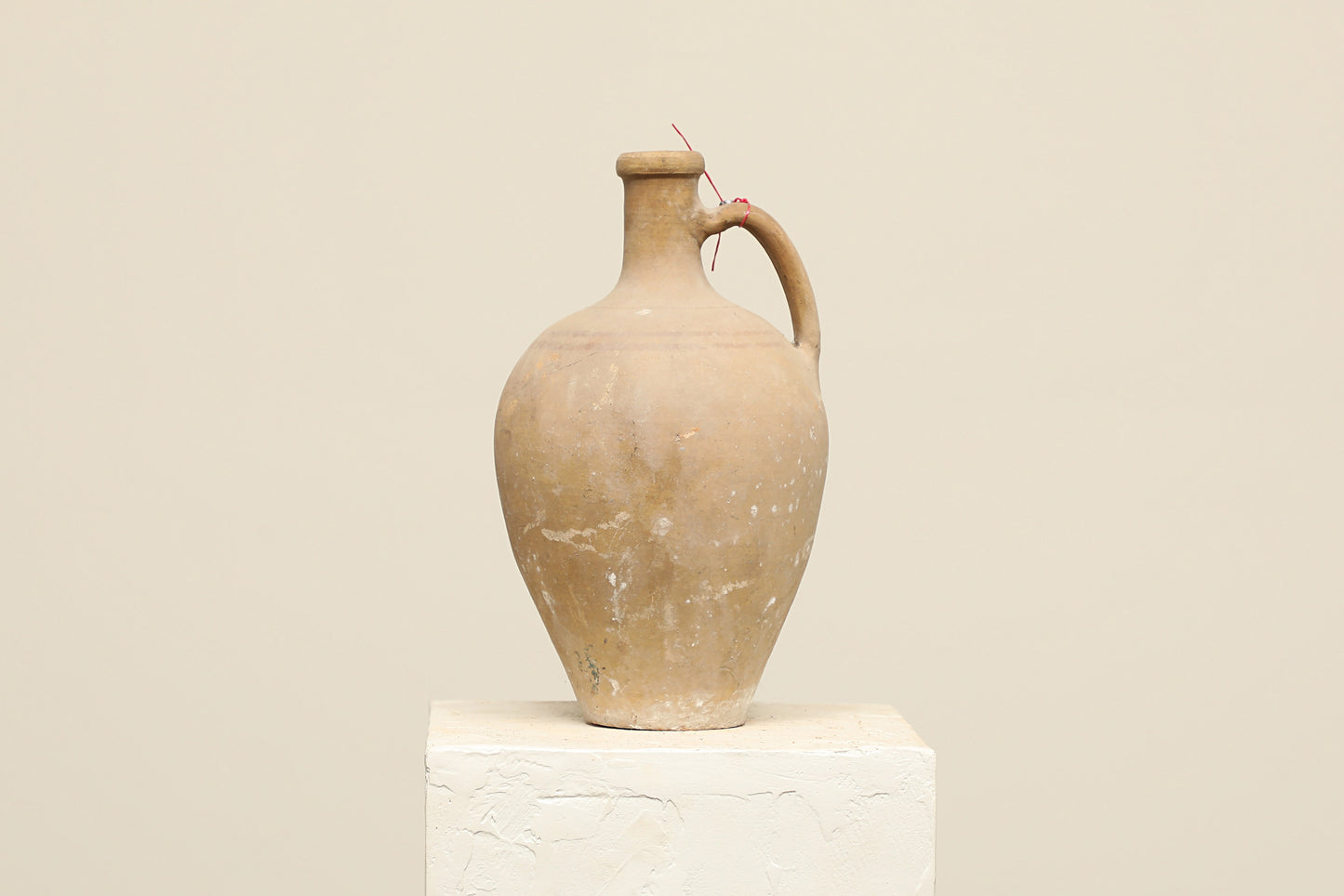A one-of-a-kind cream Turkish vintage vase pot with a handle, crafted from terra cotta clay, this piece showcases timeless quality and antique craftsmanship, adding a unique touch of history to your space