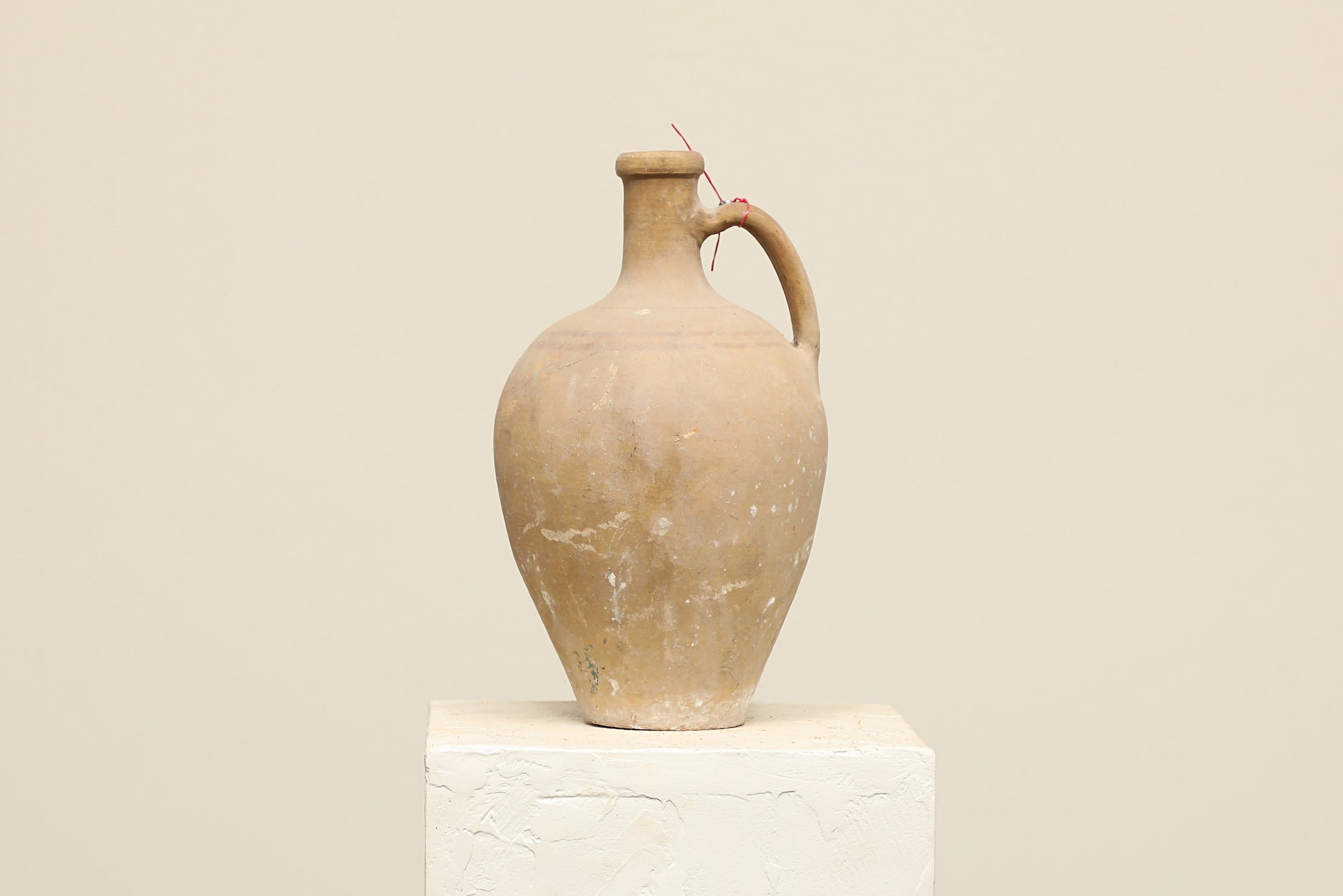 A one-of-a-kind cream Turkish vintage vase pot with a handle, crafted from terra cotta clay, this piece showcases timeless quality and antique craftsmanship, adding a unique touch of history to your space