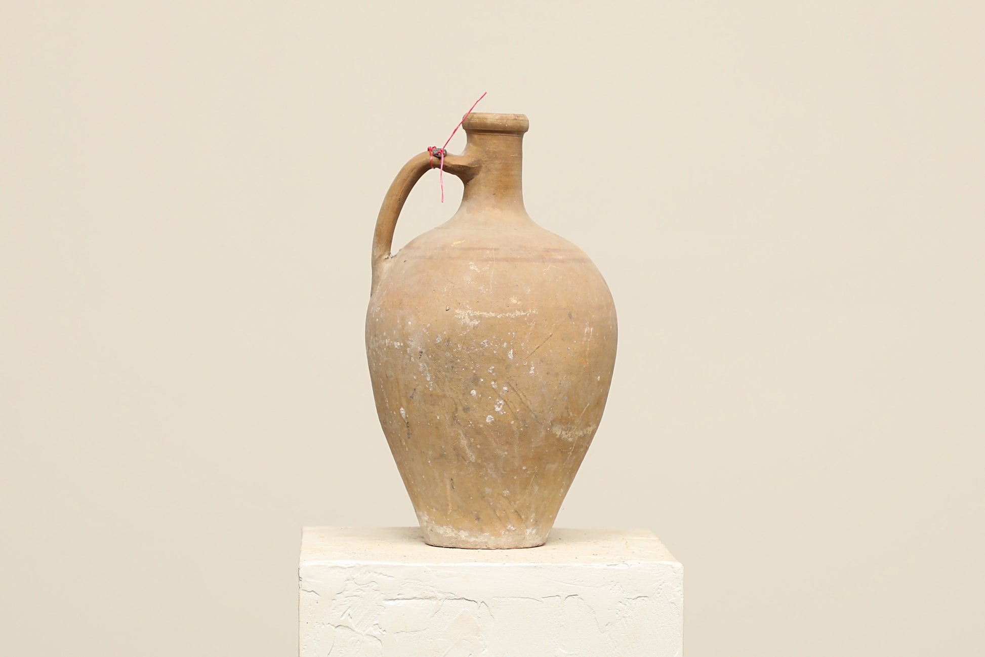 A one-of-a-kind cream Turkish vintage vase pot with a handle, crafted from terra cotta clay, this piece showcases timeless quality and antique craftsmanship, adding a unique touch of history to your space
