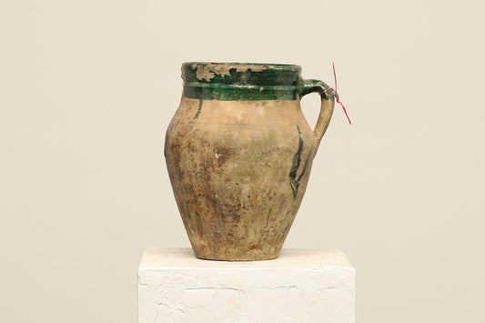 A one-of-a-kind dark brown Turkish vintage vase pot with a handle, crafted from terra cotta clay, this piece showcases timeless quality and antique craftsmanship, adding a unique touch of history to your space