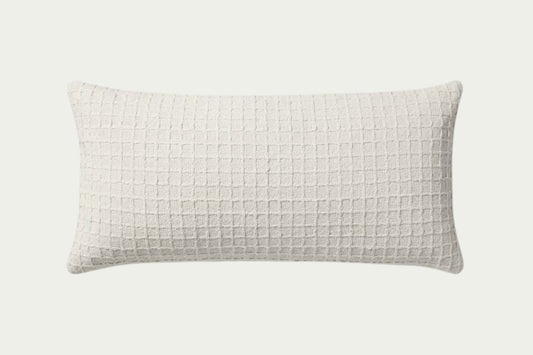 This clean ivory modern throw pillow features a stitched grid design for a hint of texture. The accent pillow cover is made of cotton and measures 12-inches by 27-inches, an elongated size to style in living rooms and bedrooms.
