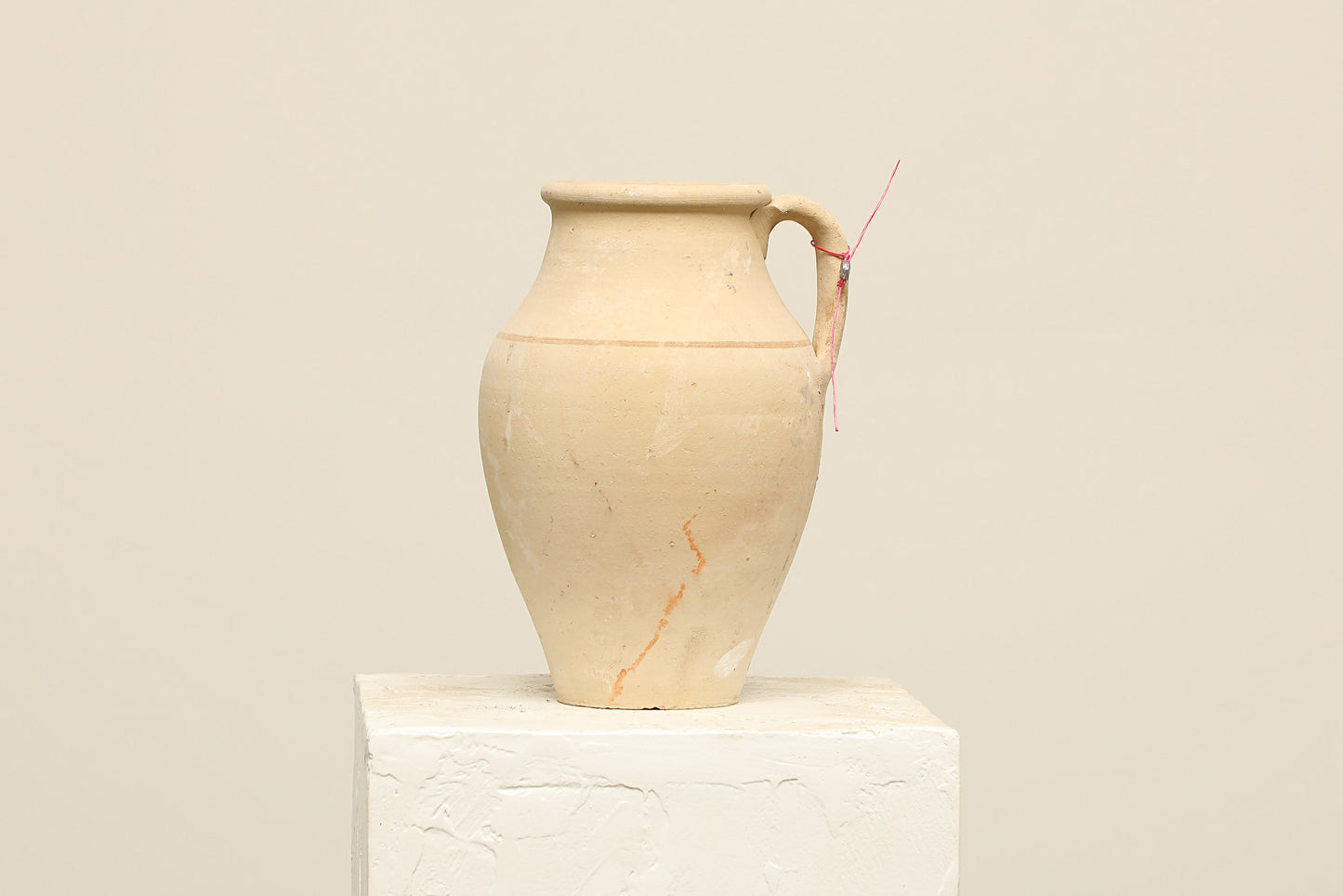 A one-of-a-kind natural Turkish vintage vase pot with a handle, crafted from terra cotta clay, this piece showcases timeless quality and antique craftsmanship, adding a unique touch of history to your space