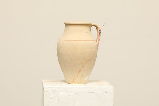 A one-of-a-kind natural Turkish vintage vase pot with a handle, crafted from terra cotta clay, this piece showcases timeless quality and antique craftsmanship, adding a unique touch of history to your space