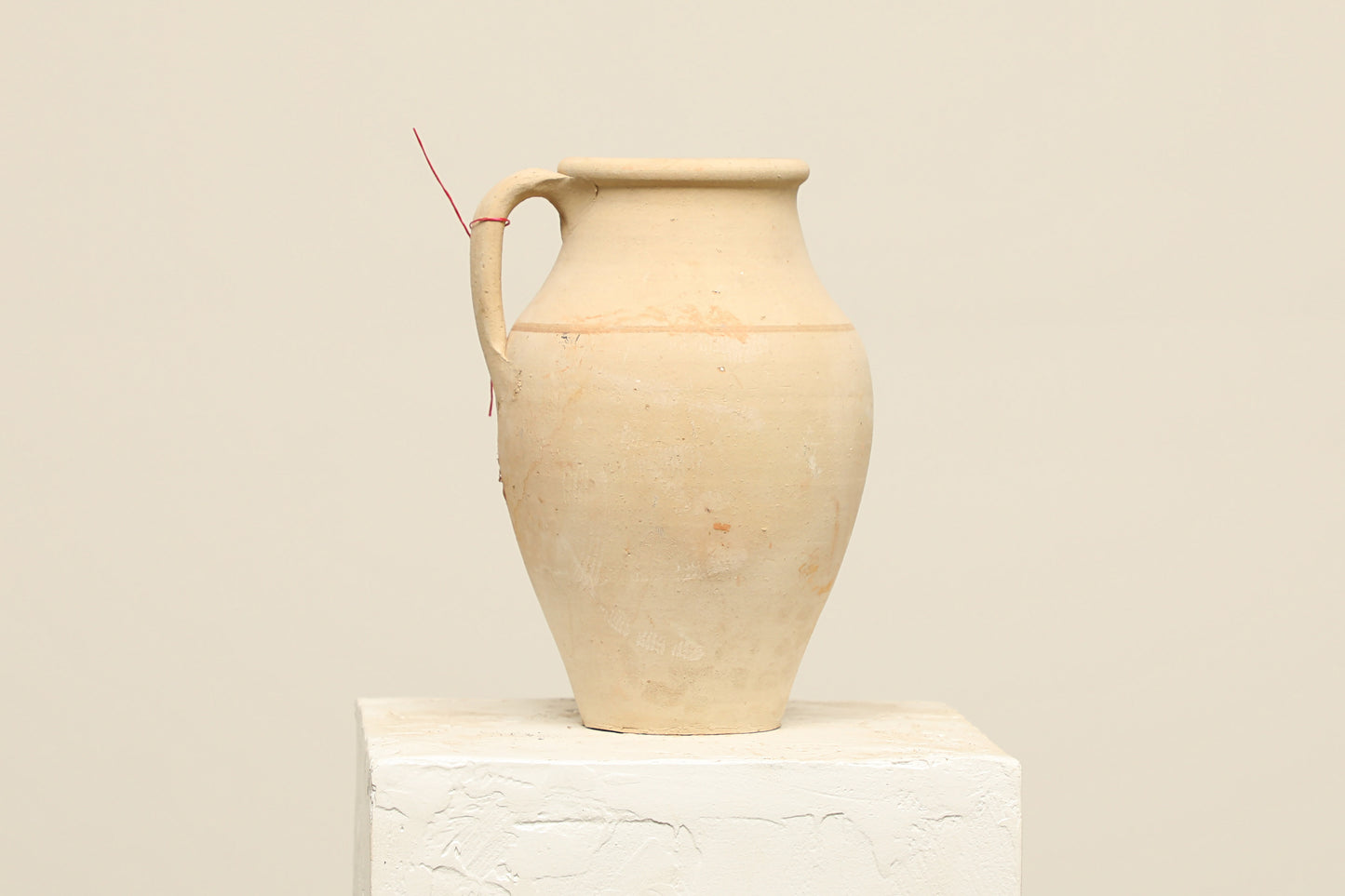 A one-of-a-kind natural Turkish vintage vase pot with a handle, crafted from terra cotta clay, this piece showcases timeless quality and antique craftsmanship, adding a unique touch of history to your space