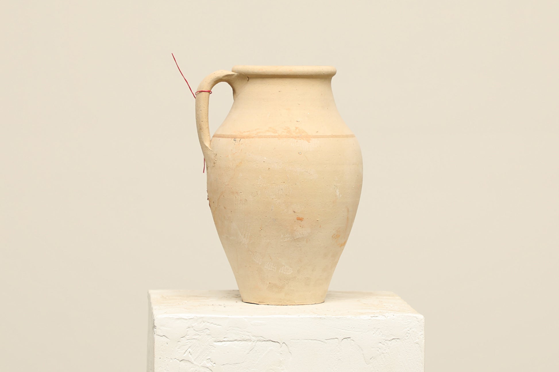 A one-of-a-kind natural Turkish vintage vase pot with a handle, crafted from terra cotta clay, this piece showcases timeless quality and antique craftsmanship, adding a unique touch of history to your space