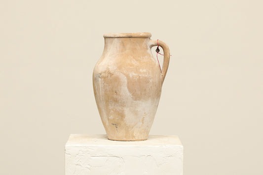 A one-of-a-kind natural Turkish vintage vase pot with a handle, crafted from terra cotta clay, this piece showcases timeless quality and antique craftsmanship, adding a unique touch of history to your space