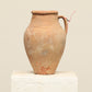 A one-of-a-kind natural Turkish vintage vase pot with a handle, crafted from terra cotta clay, this piece showcases timeless quality and antique craftsmanship, adding a unique touch of history to your space