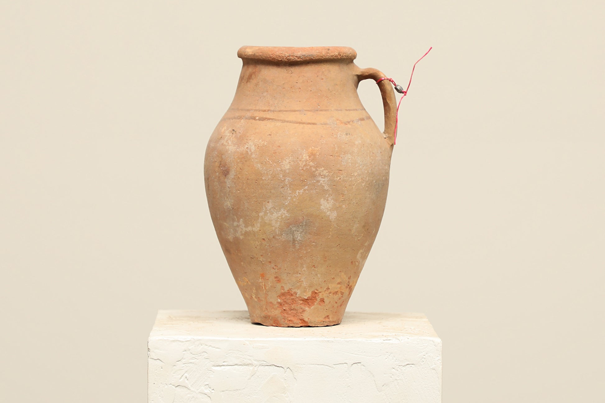 A one-of-a-kind natural Turkish vintage vase pot with a handle, crafted from terra cotta clay, this piece showcases timeless quality and antique craftsmanship, adding a unique touch of history to your space