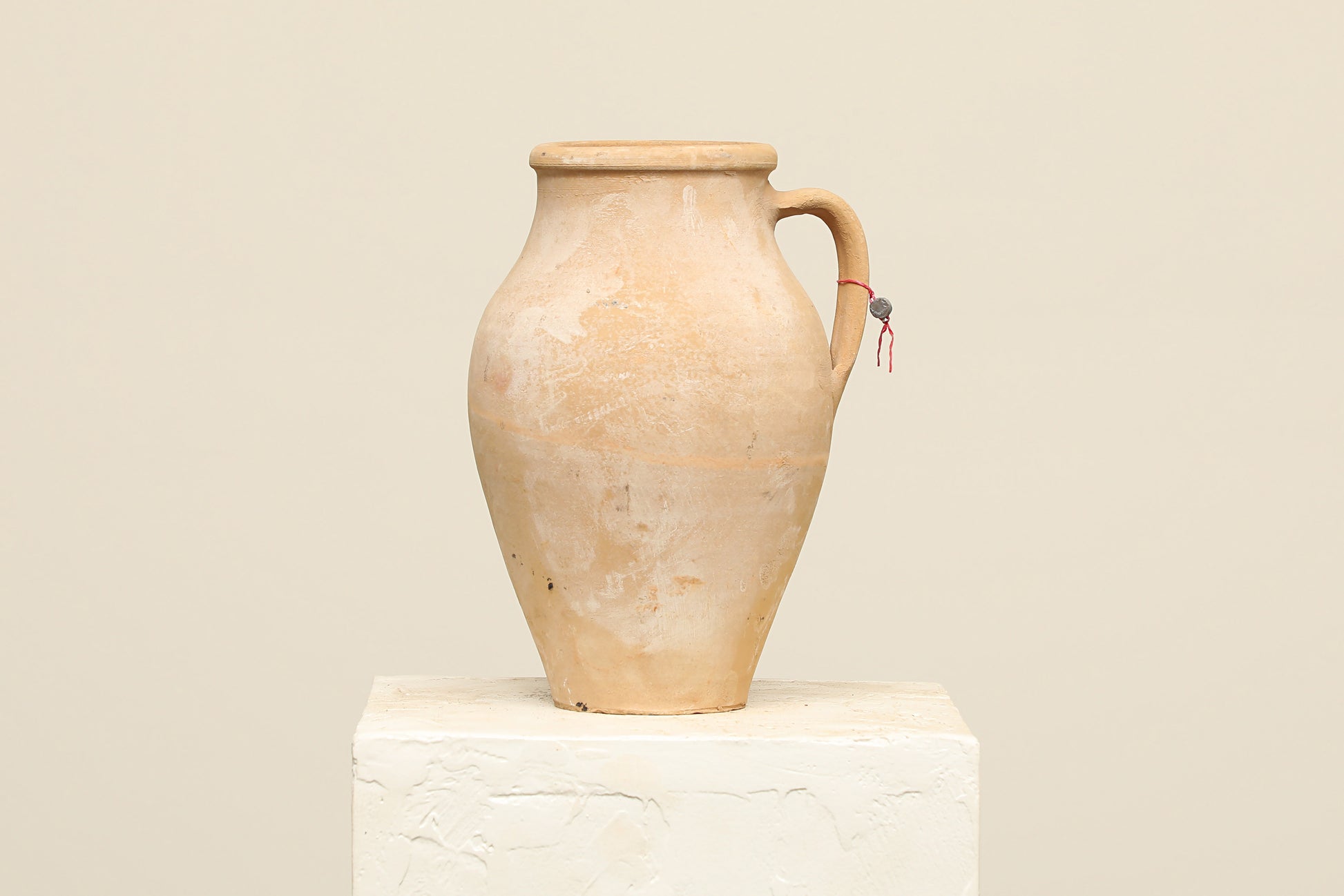 A one-of-a-kind natural Turkish vintage vase pot with a handle, crafted from terra cotta clay, this piece showcases timeless quality and antique craftsmanship, adding a unique touch of history to your space
