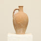 A one-of-a-kind natural Turkish vintage vase pot with a handle, crafted from terra cotta clay, this piece showcases timeless quality and antique craftsmanship, adding a unique touch of history to your space