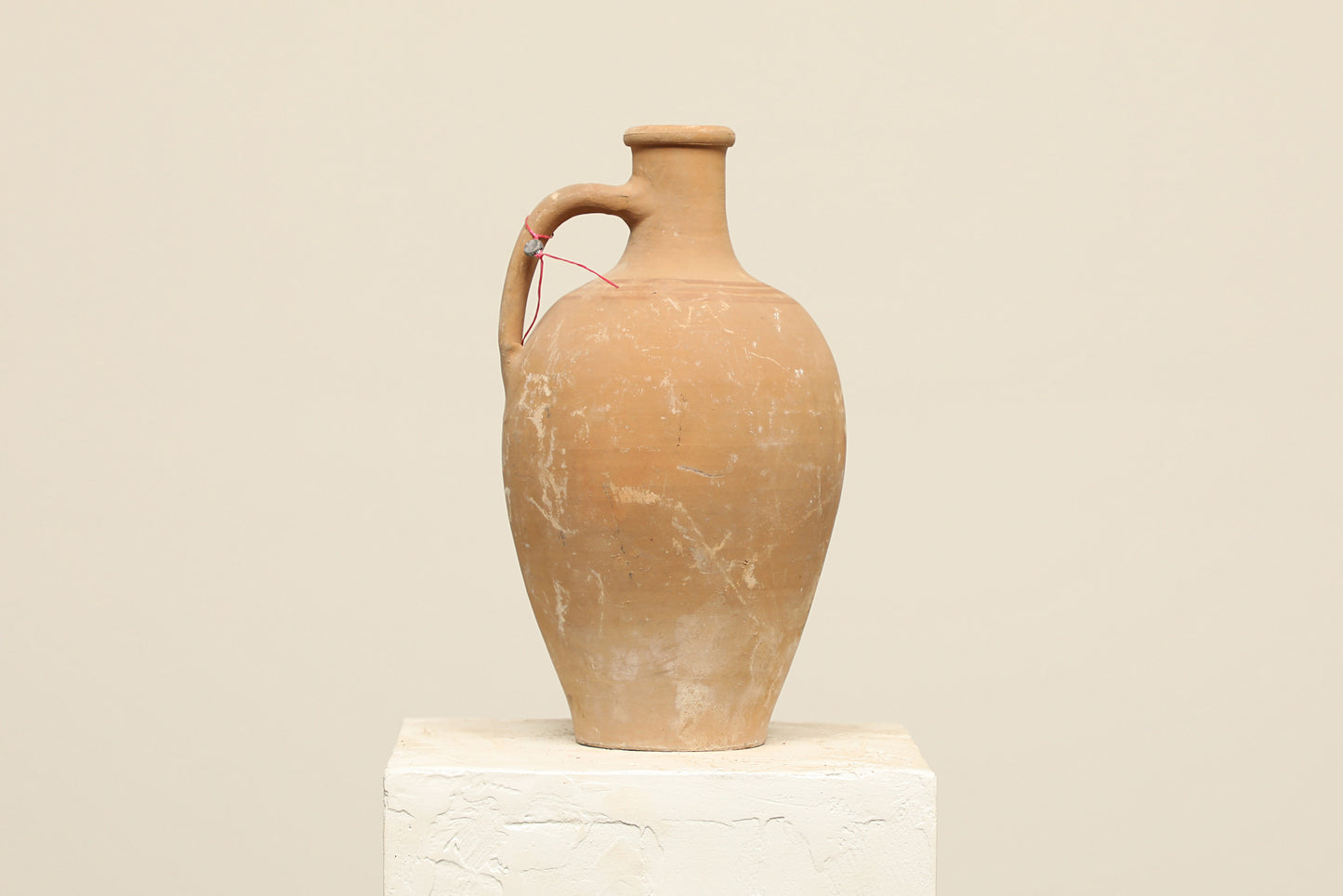 A one-of-a-kind natural Turkish vintage vase pot with a handle, crafted from terra cotta clay, this piece showcases timeless quality and antique craftsmanship, adding a unique touch of history to your space