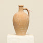 A one-of-a-kind natural Turkish vintage vase pot with a handle, crafted from terra cotta clay, this piece showcases timeless quality and antique craftsmanship, adding a unique touch of history to your space