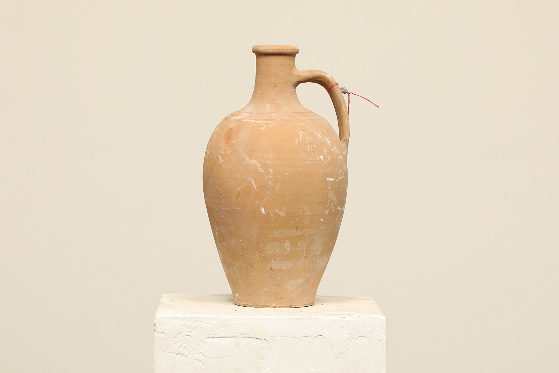 A one-of-a-kind natural Turkish vintage vase pot with a handle, crafted from terra cotta clay, this piece showcases timeless quality and antique craftsmanship, adding a unique touch of history to your space