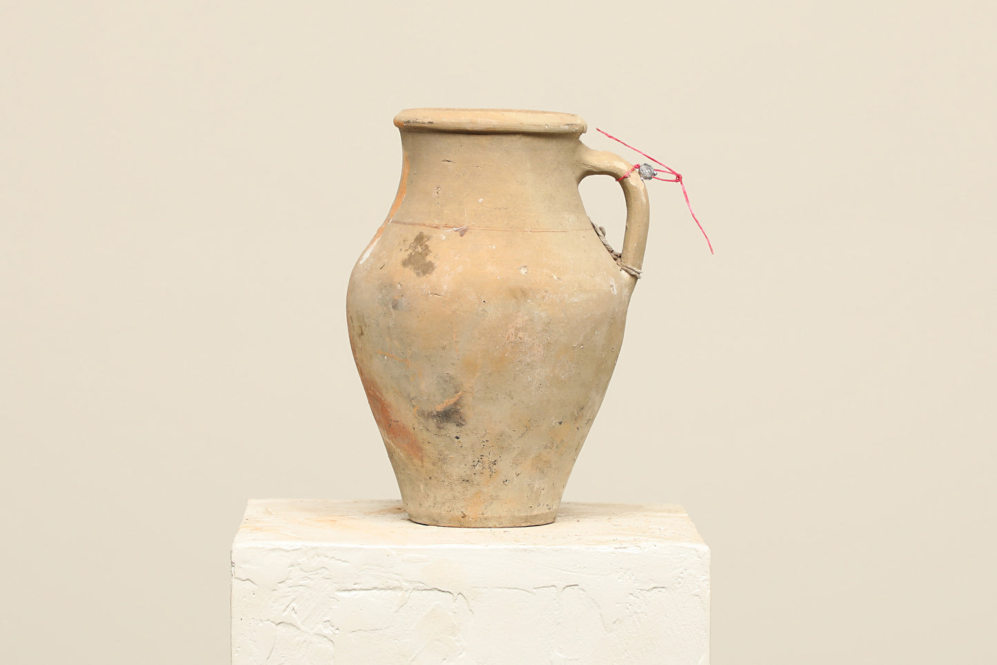 A one-of-a-kind natural Turkish vintage vase pot with a handle, crafted from terra cotta clay, this piece showcases timeless quality and antique craftsmanship, adding a unique touch of history to your space