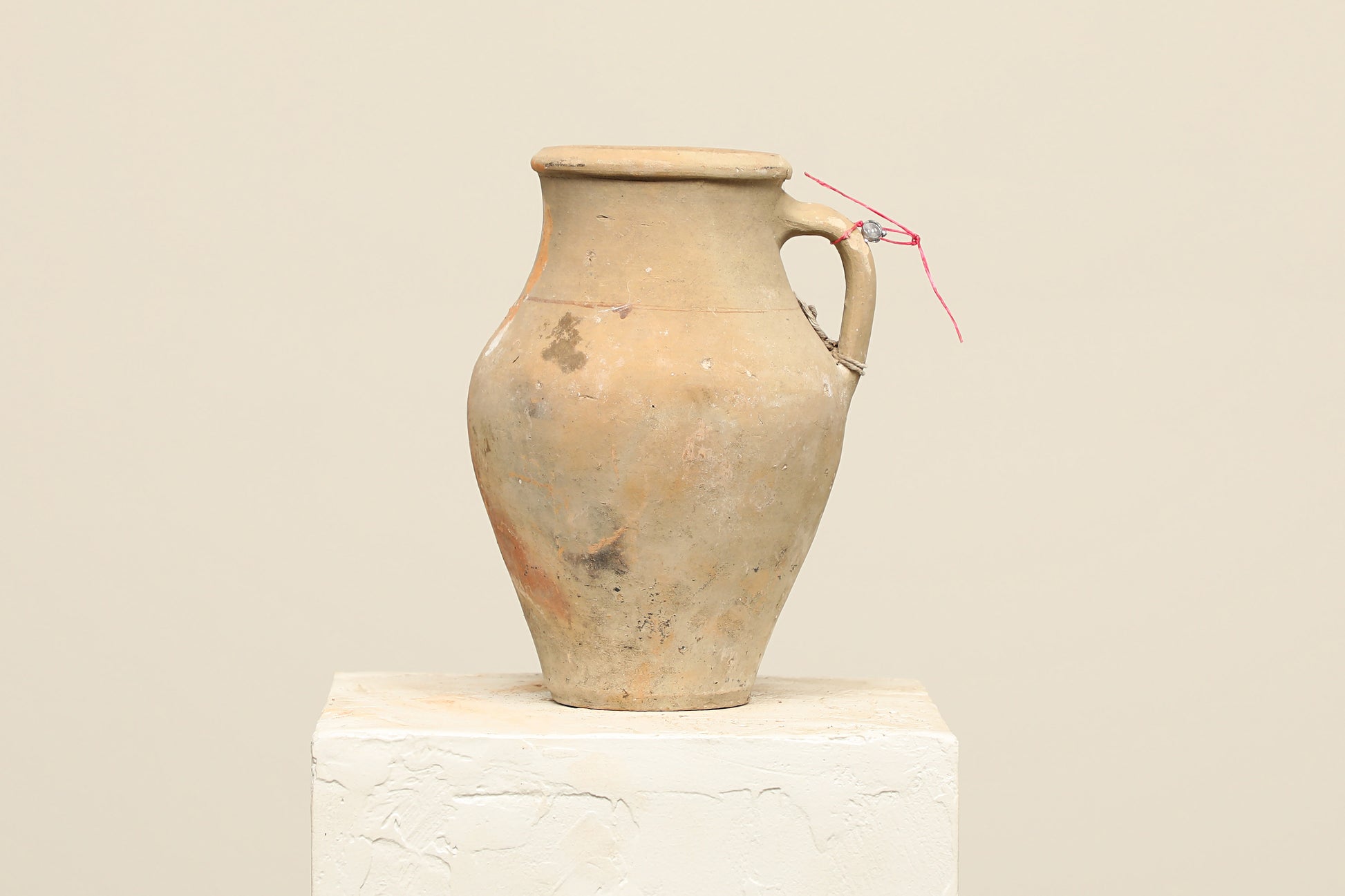 A one-of-a-kind natural Turkish vintage vase pot with a handle, crafted from terra cotta clay, this piece showcases timeless quality and antique craftsmanship, adding a unique touch of history to your space