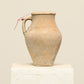 A one-of-a-kind natural Turkish vintage vase pot with a handle, crafted from terra cotta clay, this piece showcases timeless quality and antique craftsmanship, adding a unique touch of history to your space