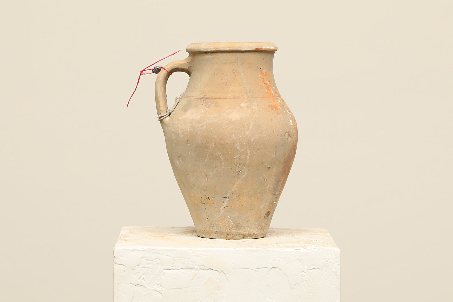 A one-of-a-kind natural Turkish vintage vase pot with a handle, crafted from terra cotta clay, this piece showcases timeless quality and antique craftsmanship, adding a unique touch of history to your space