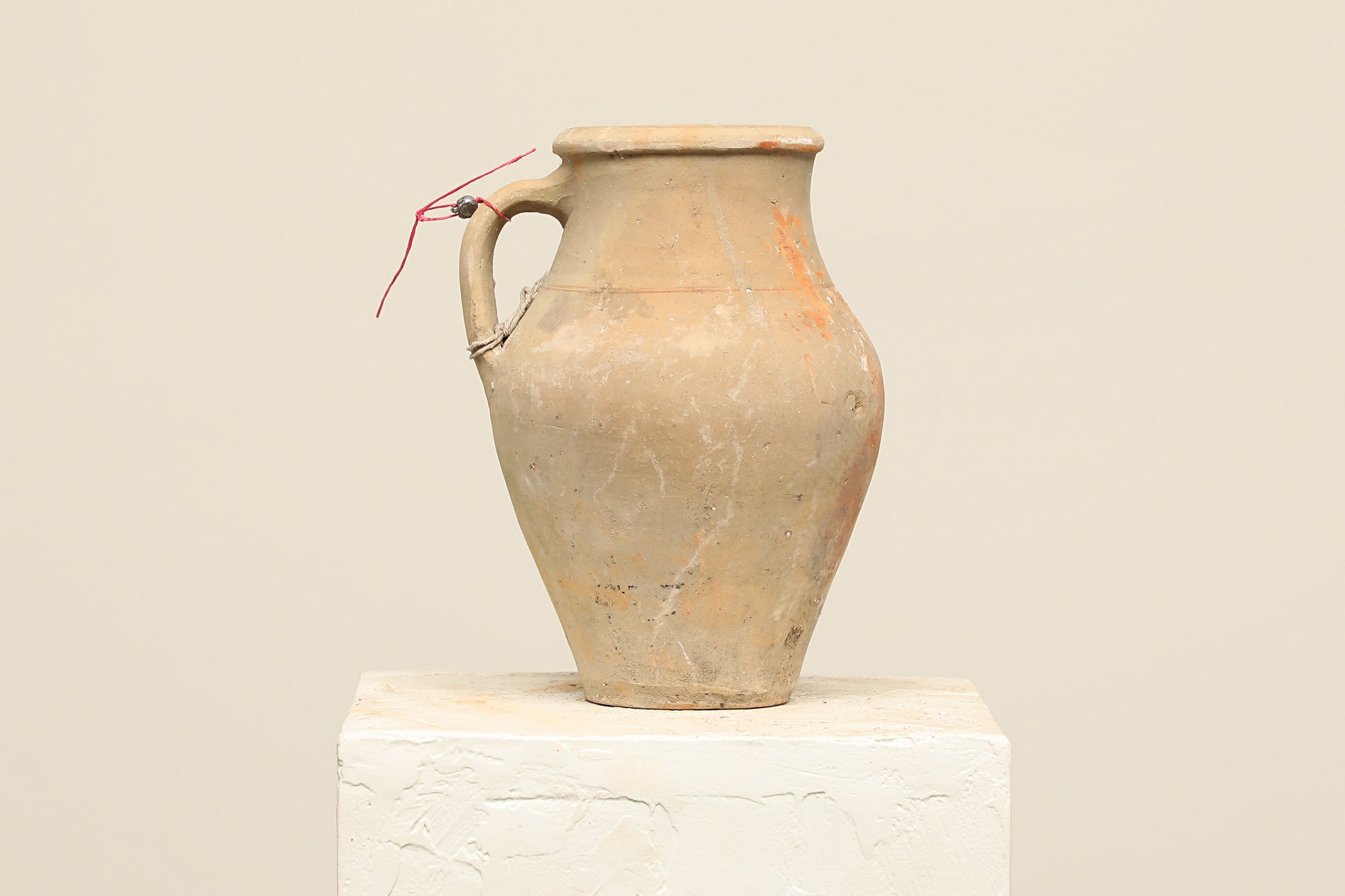 A one-of-a-kind natural Turkish vintage vase pot with a handle, crafted from terra cotta clay, this piece showcases timeless quality and antique craftsmanship, adding a unique touch of history to your space