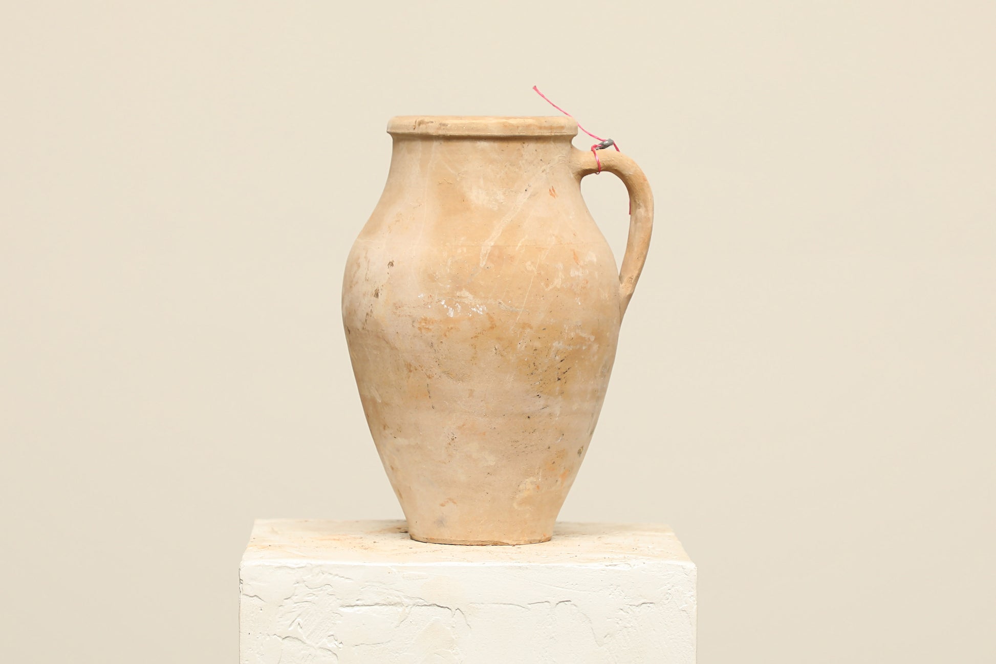 A one-of-a-kind natural Turkish vintage vase pot with a handle, crafted from terra cotta clay, this piece showcases timeless quality and antique craftsmanship, adding a unique touch of history to your space