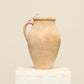 A one-of-a-kind natural Turkish vintage vase pot with a handle, crafted from terra cotta clay, this piece showcases timeless quality and antique craftsmanship, adding a unique touch of history to your space