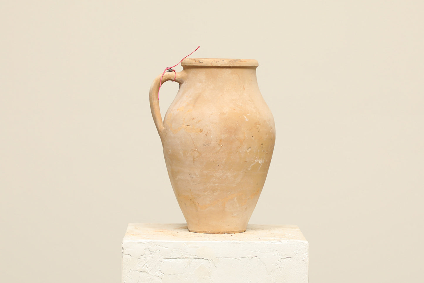 A one-of-a-kind natural Turkish vintage vase pot with a handle, crafted from terra cotta clay, this piece showcases timeless quality and antique craftsmanship, adding a unique touch of history to your space