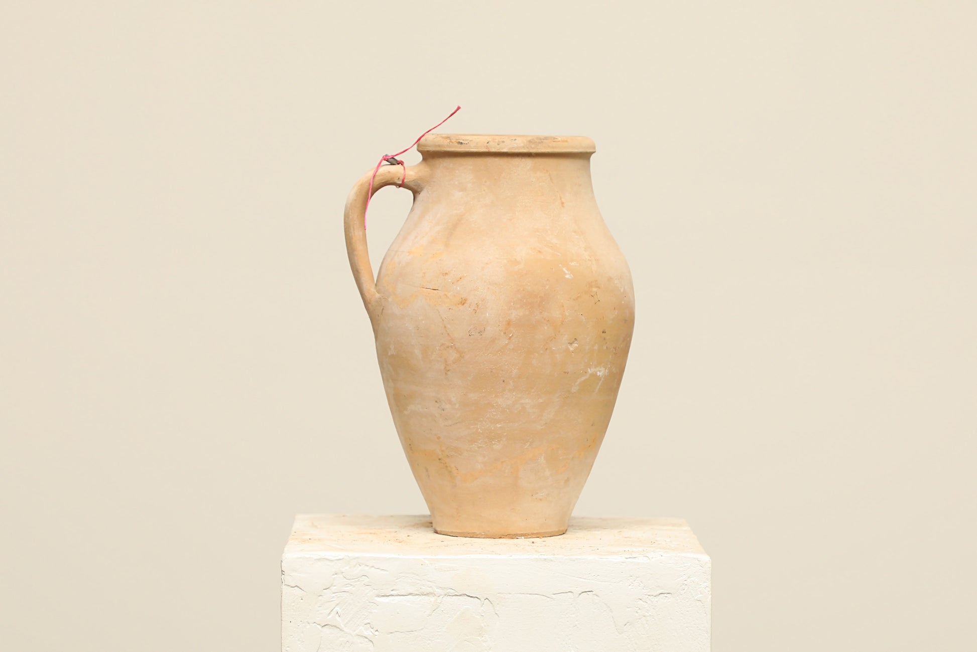 A one-of-a-kind natural Turkish vintage vase pot with a handle, crafted from terra cotta clay, this piece showcases timeless quality and antique craftsmanship, adding a unique touch of history to your space