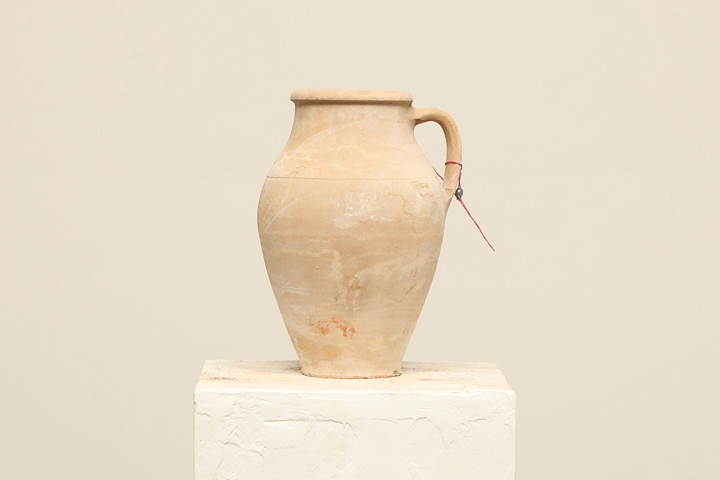 A one-of-a-kind natural Turkish vintage vase pot with a handle, crafted from terra cotta clay, this piece showcases timeless quality and antique craftsmanship, adding a unique touch of history to your space