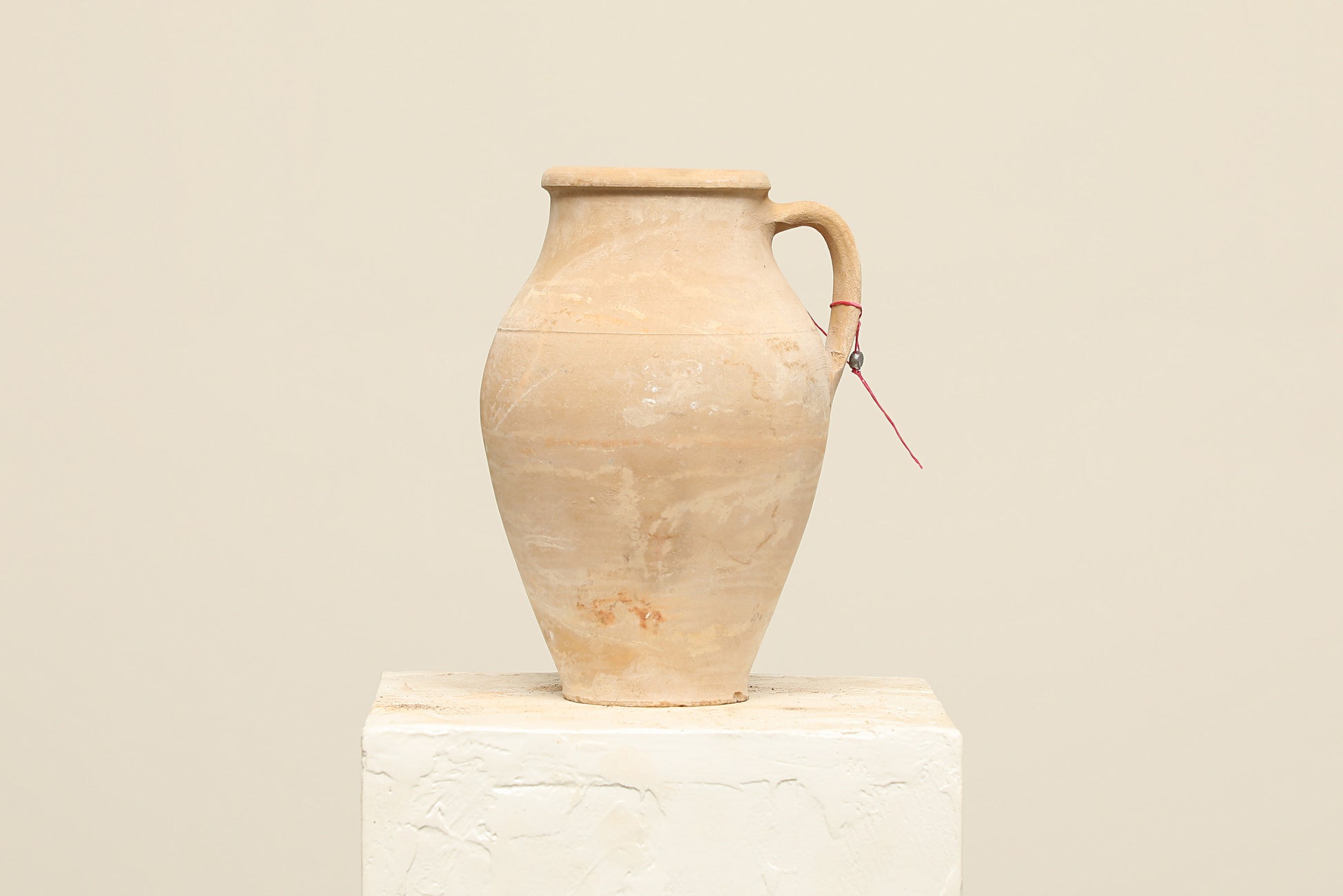 A one-of-a-kind natural Turkish vintage vase pot with a handle, crafted from terra cotta clay, this piece showcases timeless quality and antique craftsmanship, adding a unique touch of history to your space